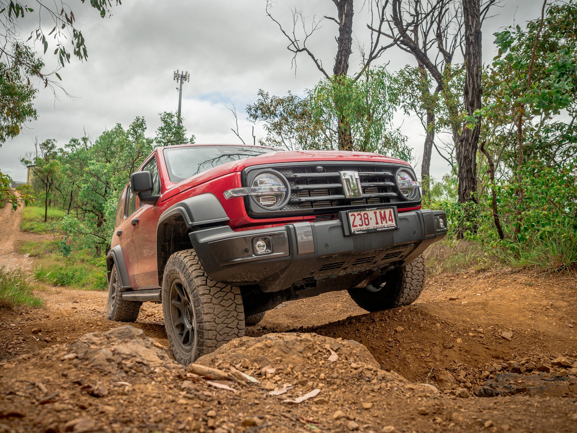 GWM Tank 300 flexing off-road with Dobinsons suspension installed, showcasing lift height and articulation.